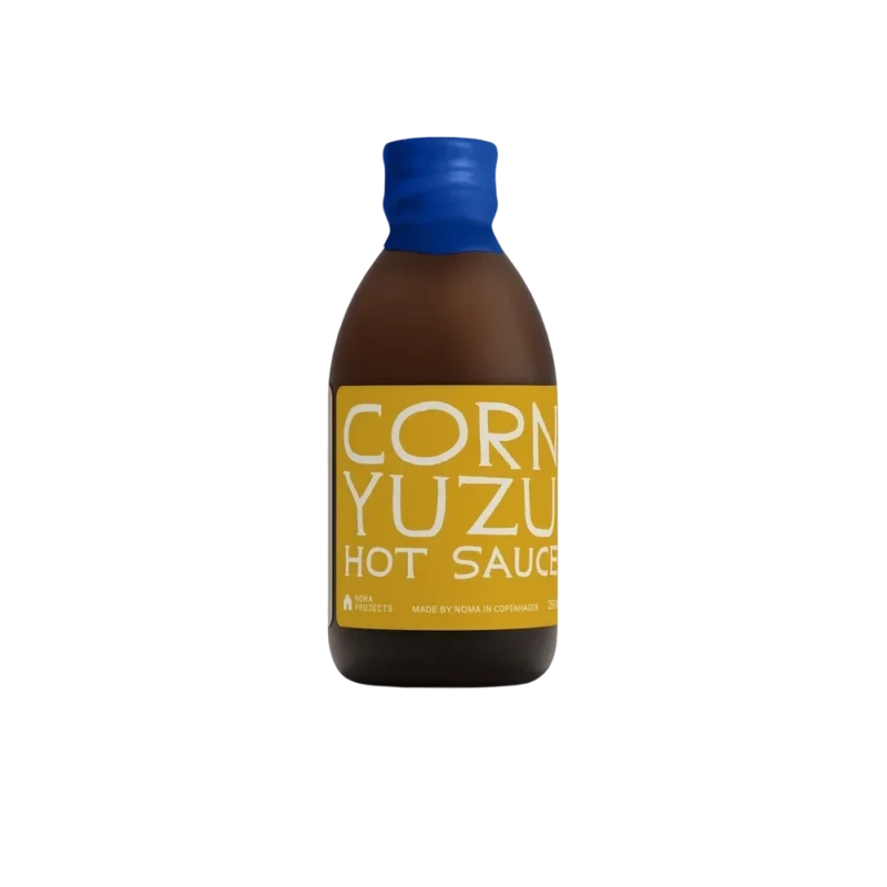 Noma Projects Corn Yuzu Hot Sauce – artisan condiment, amber bottle with yellow label and blue cap