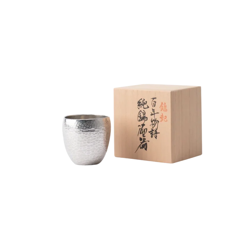 Seigado Tales of a Century Hammered Tin Guinomi Sake Cup — hand-hammered pure tin sake cup with honeycomb tsuiki pattern, shown with traditional wooden gift box featuring Japanese calligraphy