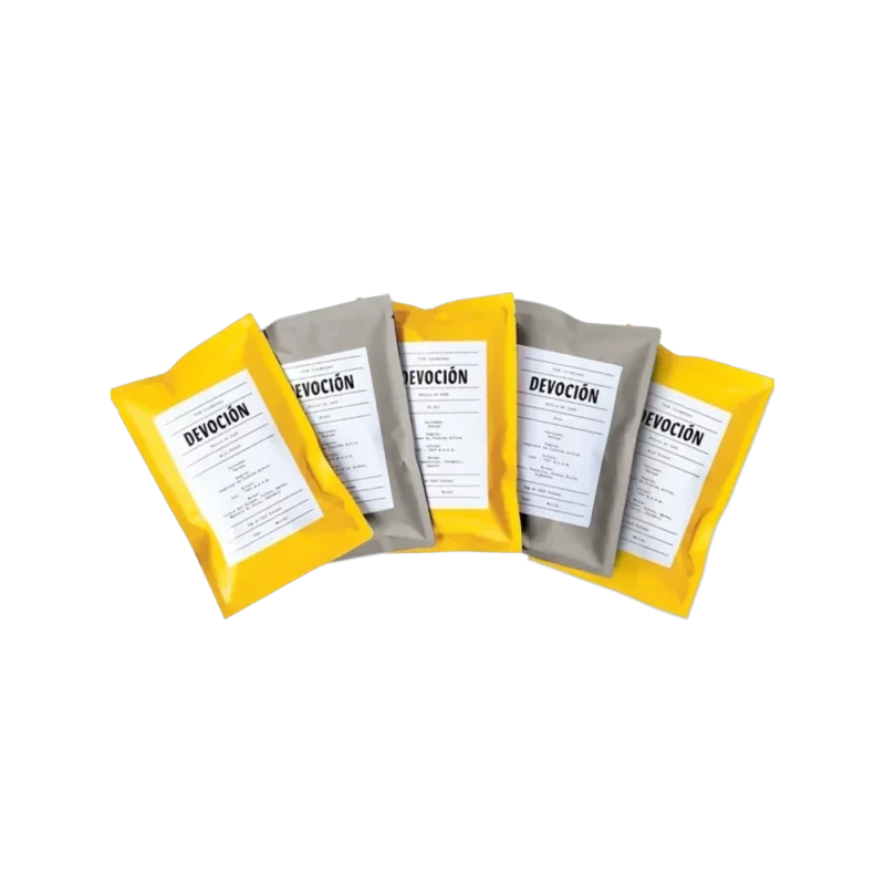 Devoción House Blend Coffee Sampler — five 2oz sachets in yellow and grey packaging, fanned out showing blend labels