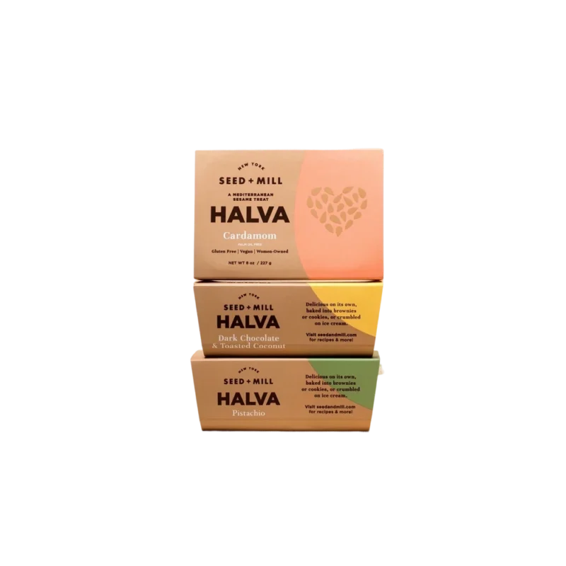 Seed + Mill Nostalgia Halva Trio — three stacked halva boxes in Cardamom, Dark Chocolate Toasted Coconut, Seed + Mill Nostalgia Halva Trio — three stacked halva boxes in Cardamom, Dark Chocolate Toasted Coconut, and Pistachio with sesame heart design
