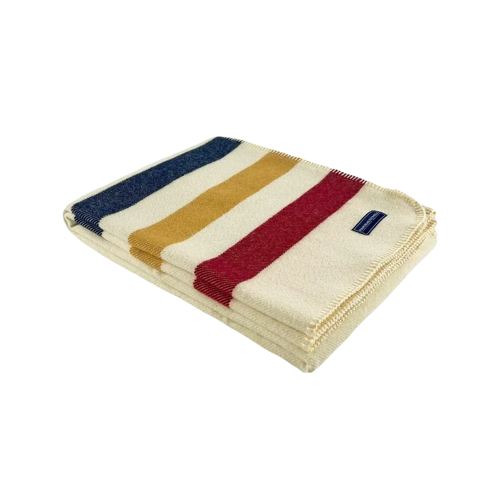 Faribault Mill Frontier Wool Throw – striped wool blanket with red, golden yellow, and navy stripes on natural cream background, folded with blue Faribault Mill label visible