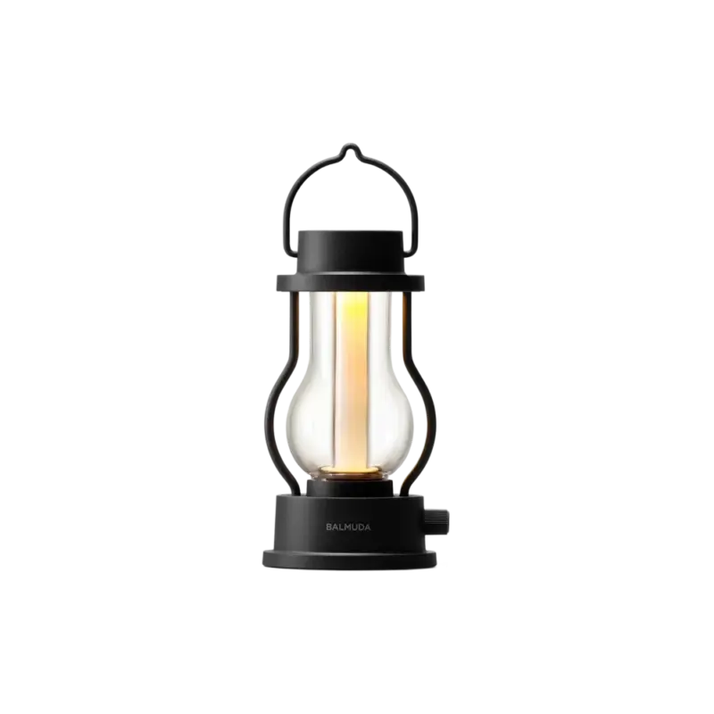 BALMUDA The Lantern — rechargeable LED lantern, matte black frame with warm amber glow through frosted glass tube