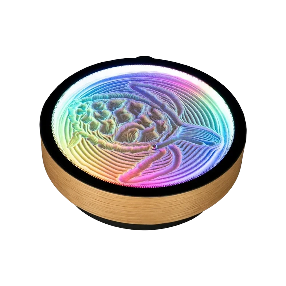 Oasis Mini kinetic sand art canvas, round with a wood grain band and black rim, a turtle pattern in rainbow lit sand